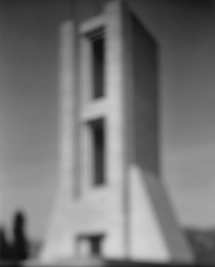 Black-and-white photograph of out of focus tower with two elongated rectangle cutouts