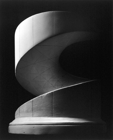 Black-and-white photograph of a cylinder with an inset spiralling ramp
