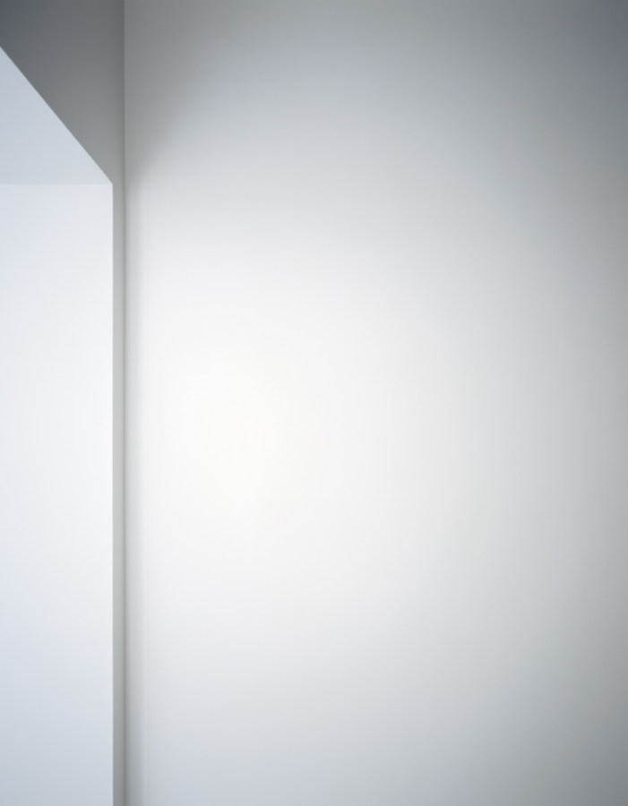 Photograph of a white wall next to a window cut out in varying shades of light gray