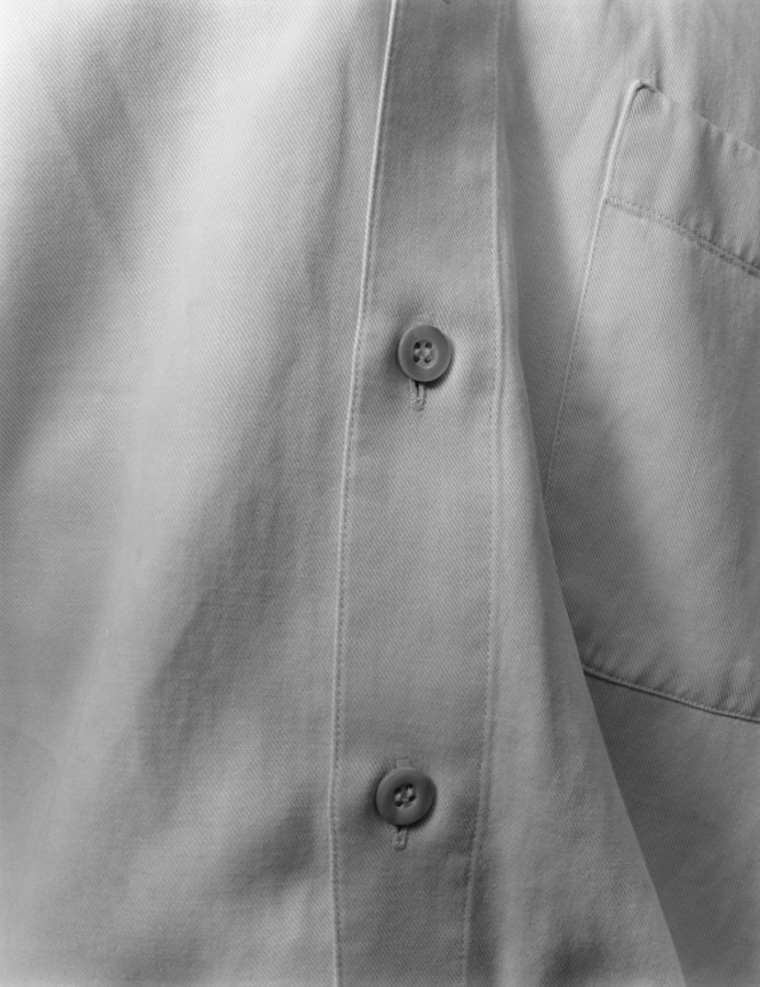 Black-and-white close-up photograph of the buttons of a shirt