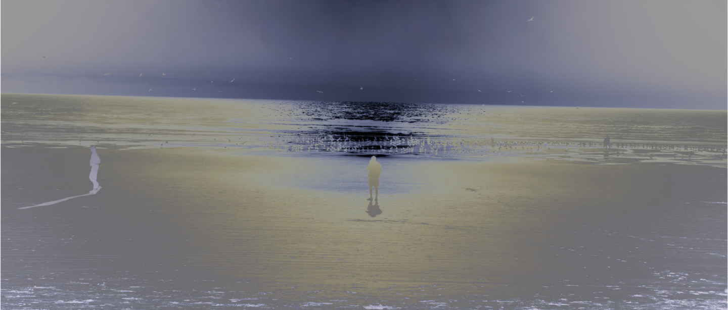 Inverted color photograph of a person standing on the seashore looking at the horizon