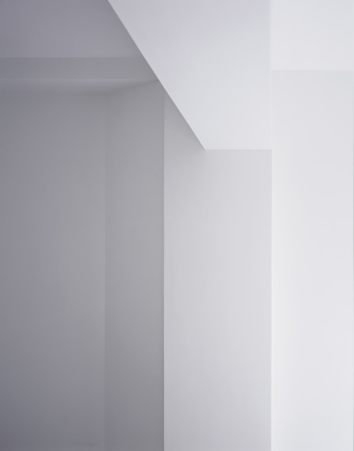 Photograph of a white ceiling and wall meeting