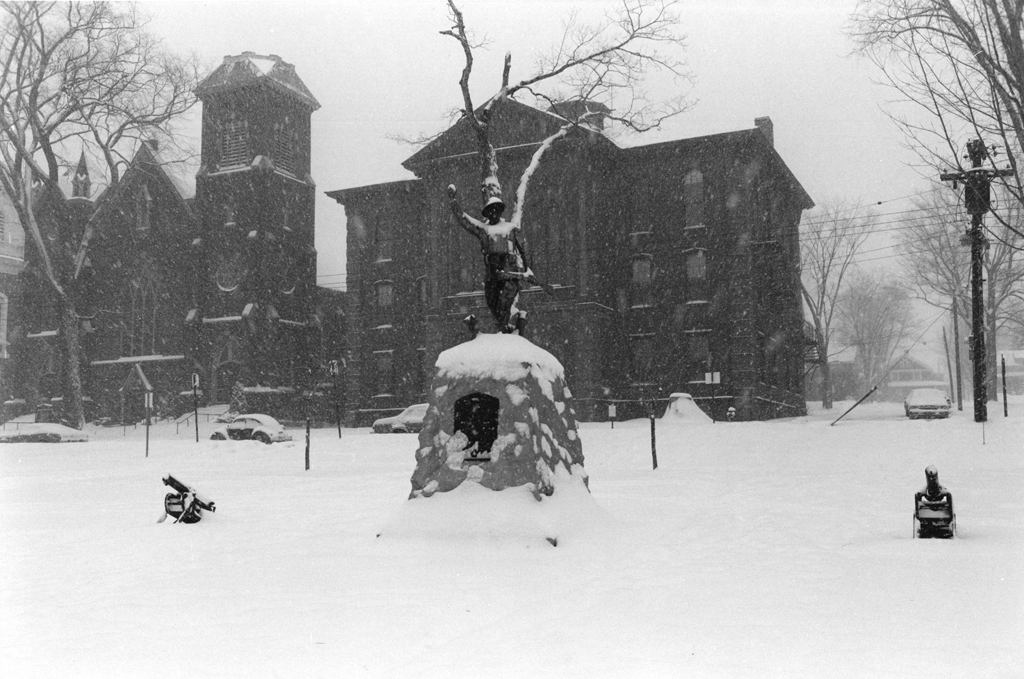 Black and white photograph of a monument covered in snow