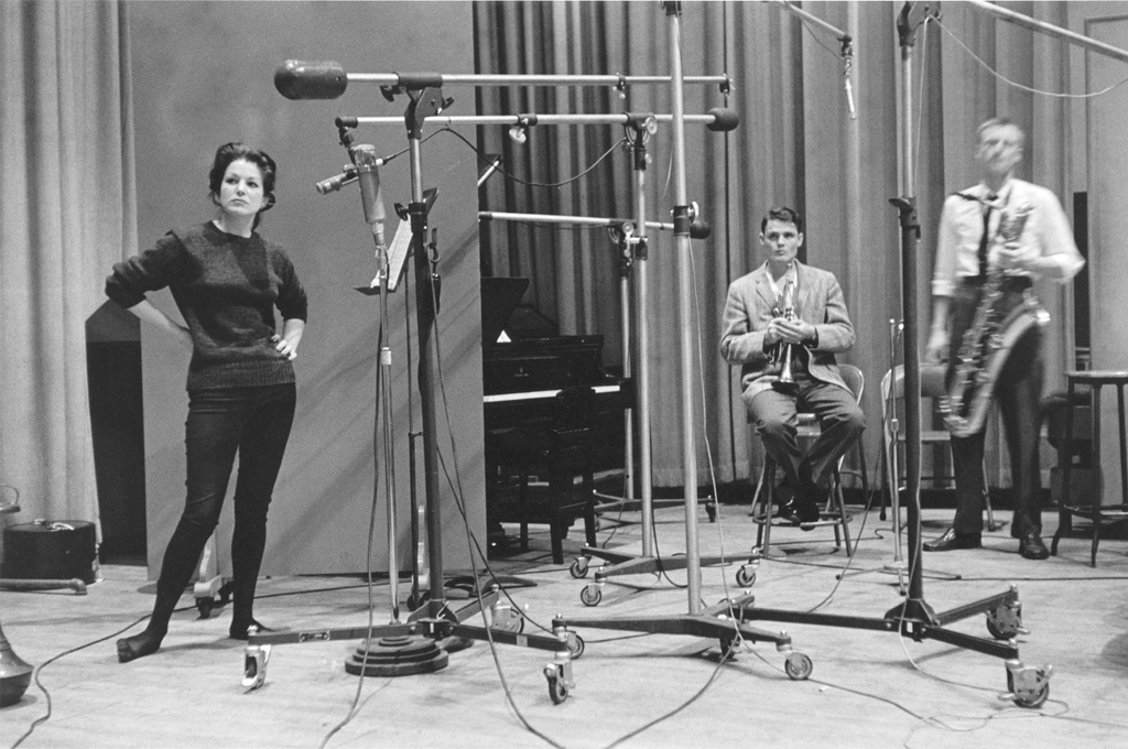 Black and white photograph of three figures with instruments and audio equipment