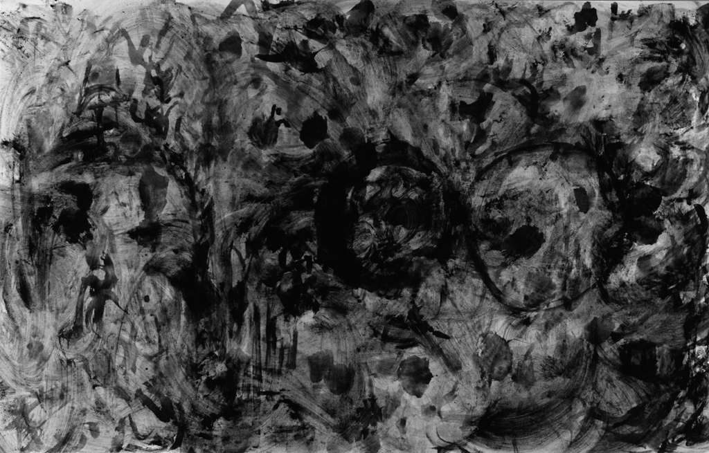 Black-and-white photograph of an abstract pattern of black blobs and swirls on a dark gray background