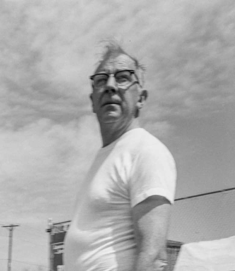 Black-and-white photograph of a man wearing glasses