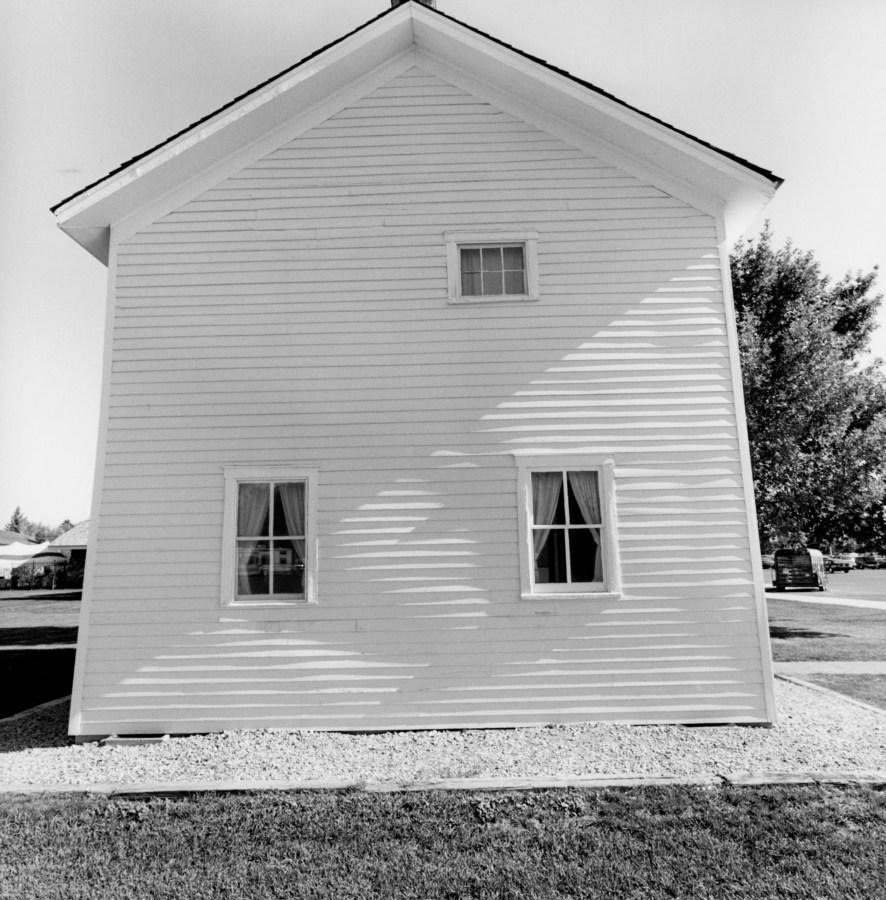 A black and white photograph of a wooden structure slightly off center