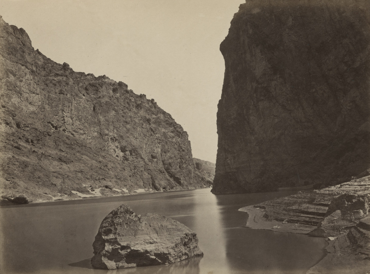 Black and white photograph of a river winding through a rocky canyon
