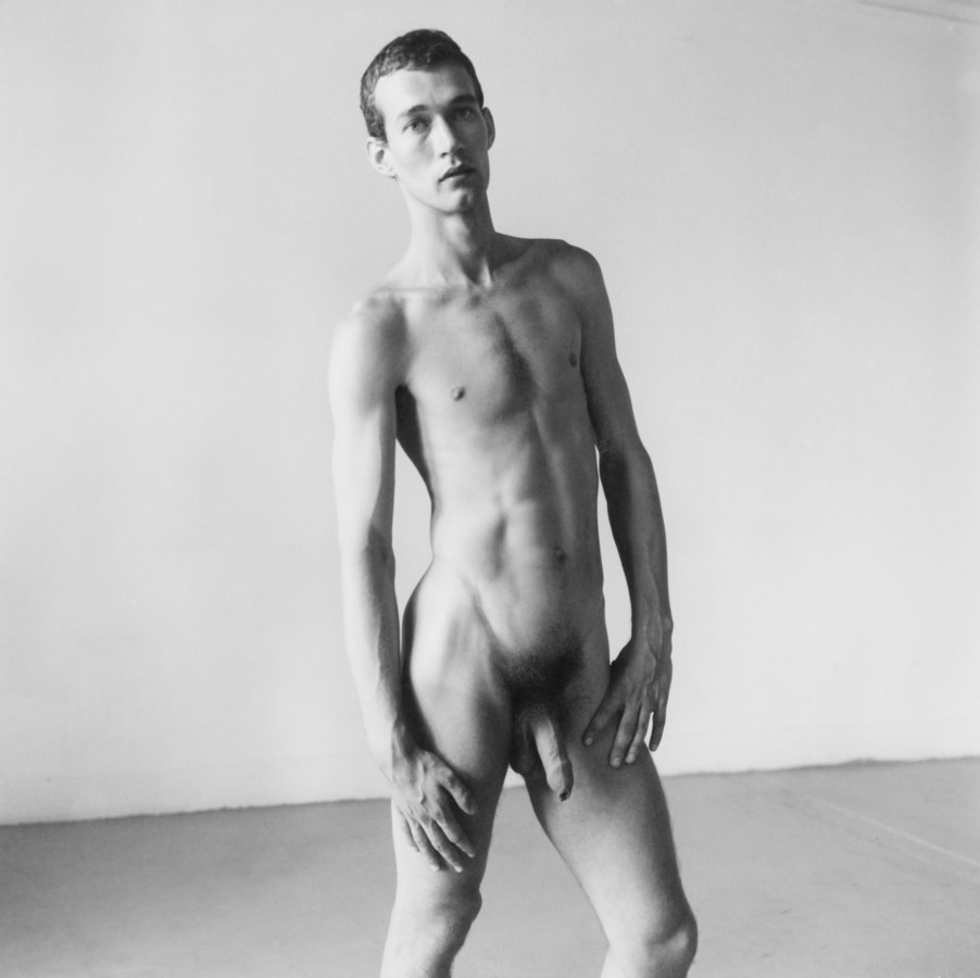 Black and white photograph of a nude male posing for camera
