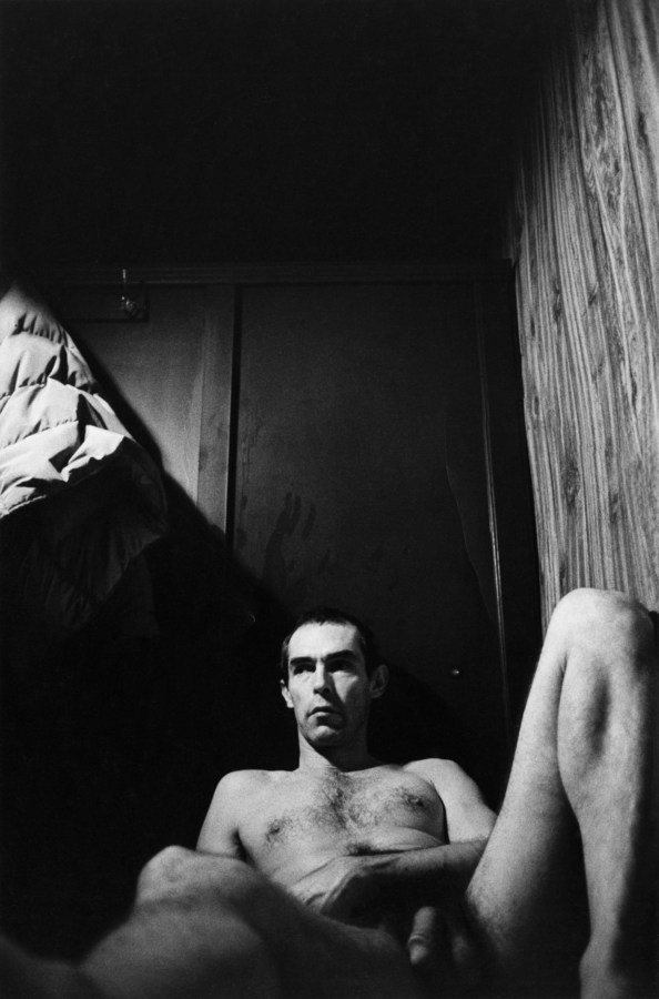 Black-and-white photograph of the photographer reclining in a bath