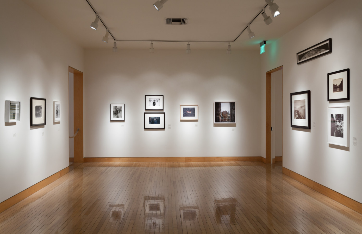 Color image of framed photographs on white gallery walls