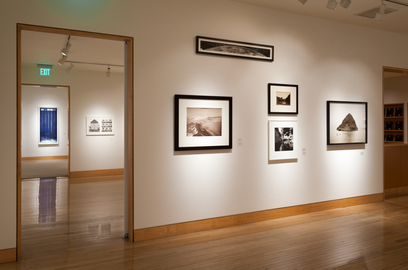 Color image of framed photographs on white gallery walls