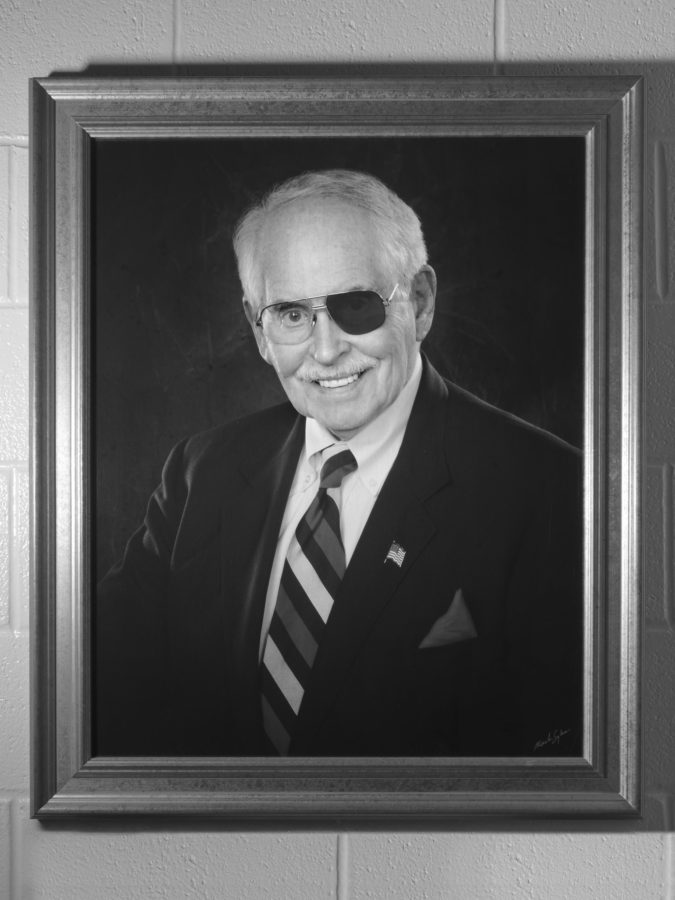 Black and white photograph of framed portrait of a man with sunglasses on