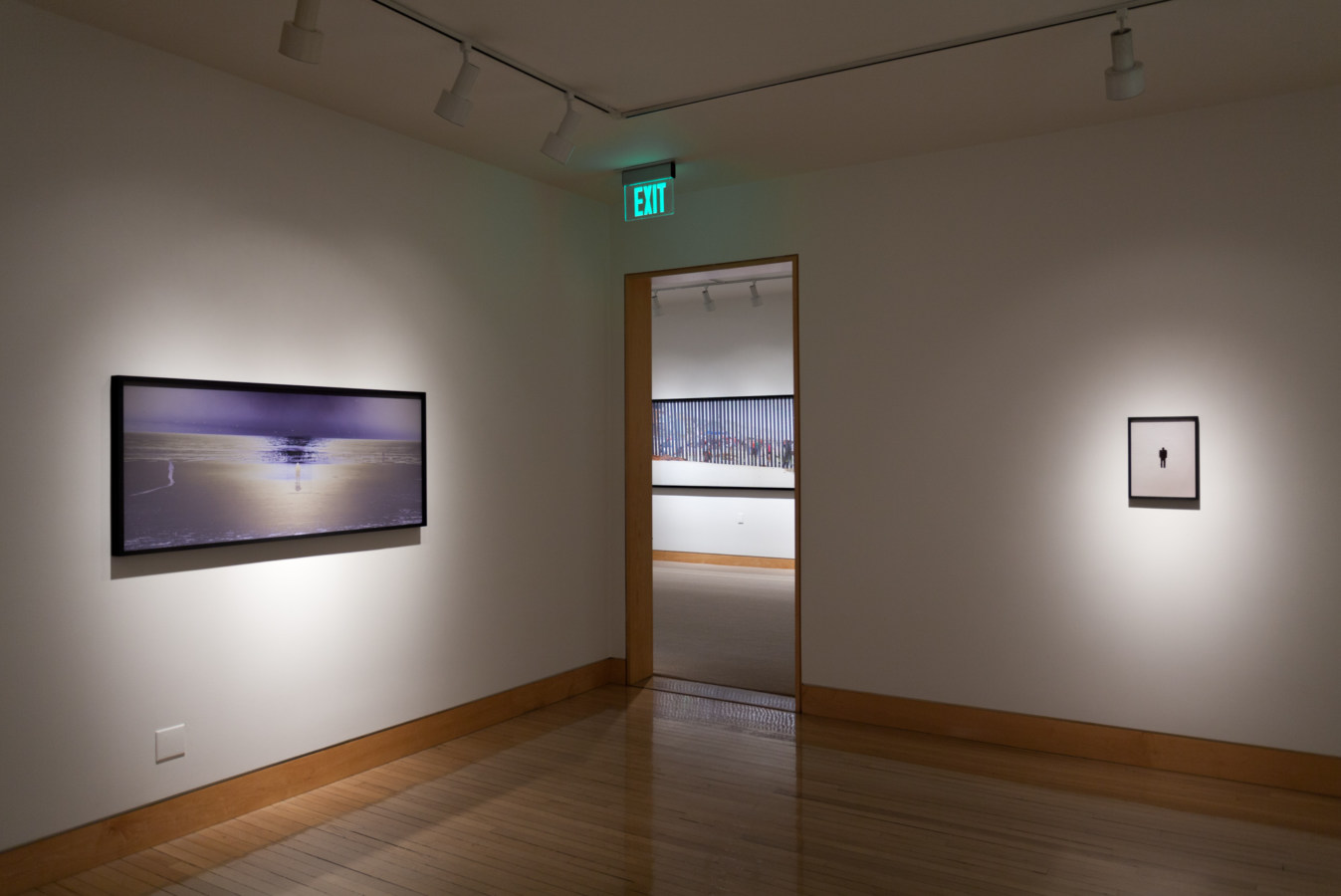 Color image of large scale color photographs on white gallery walls