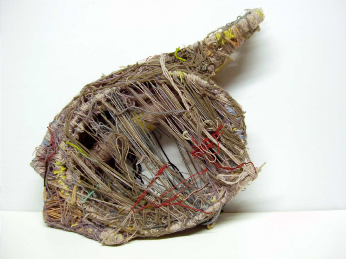 Color image of sculptural object wrapped in layers of yarn