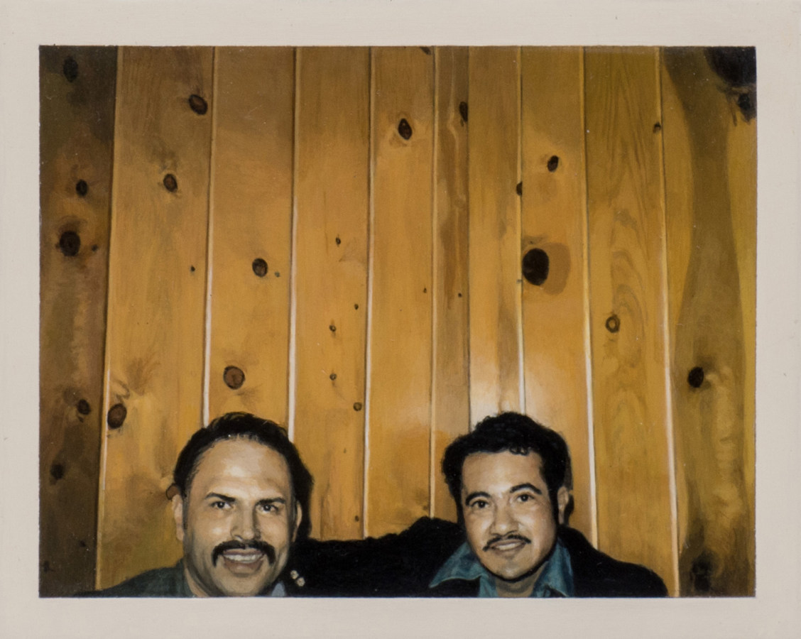 Color image of a photorealistic painting of two men smiling in front of wood paneled wall
