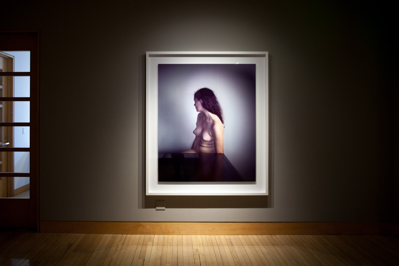 Color image of large scale color photograph on grey gallery wall