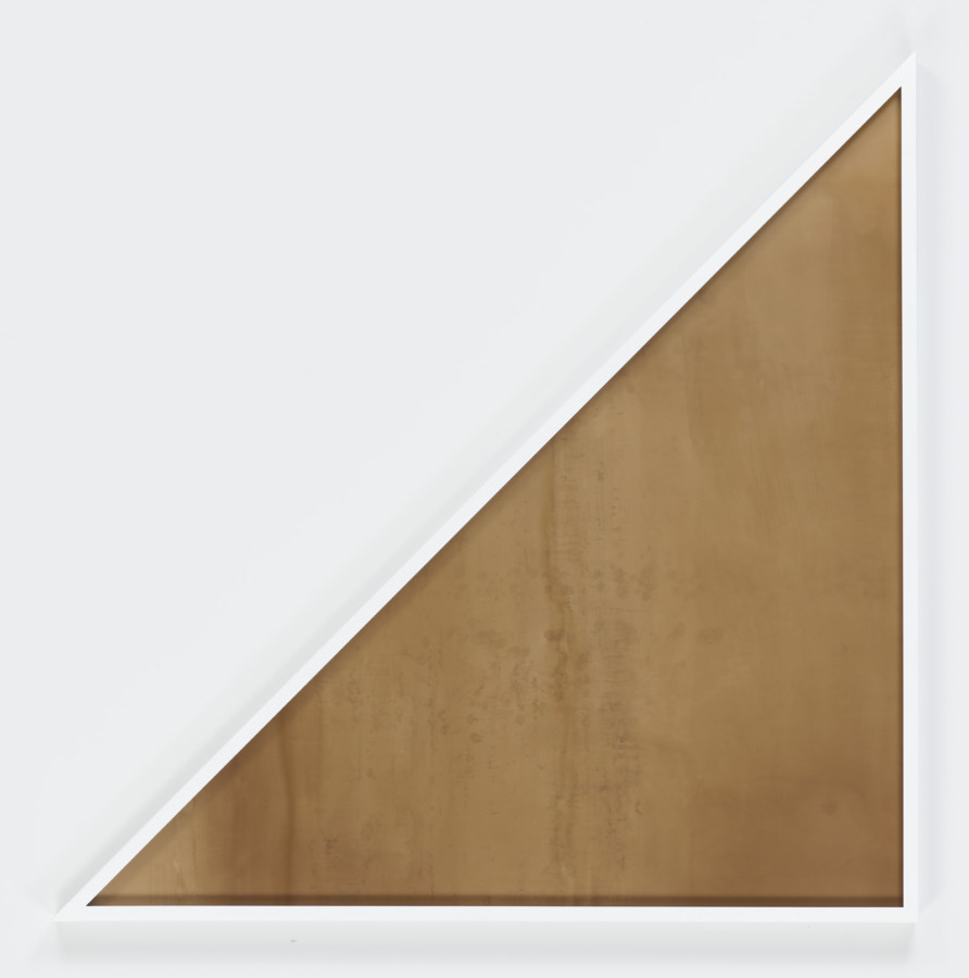 Color image of framed color photogram shaped like cornered triangle on white gallery wall