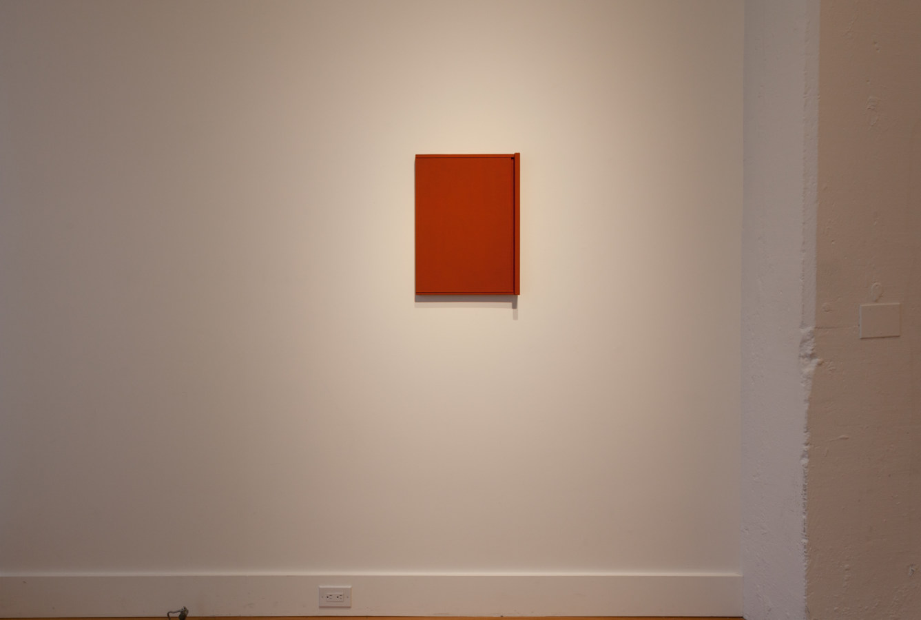 Installation photograph of a gallery space with a single red rectangle on the wall