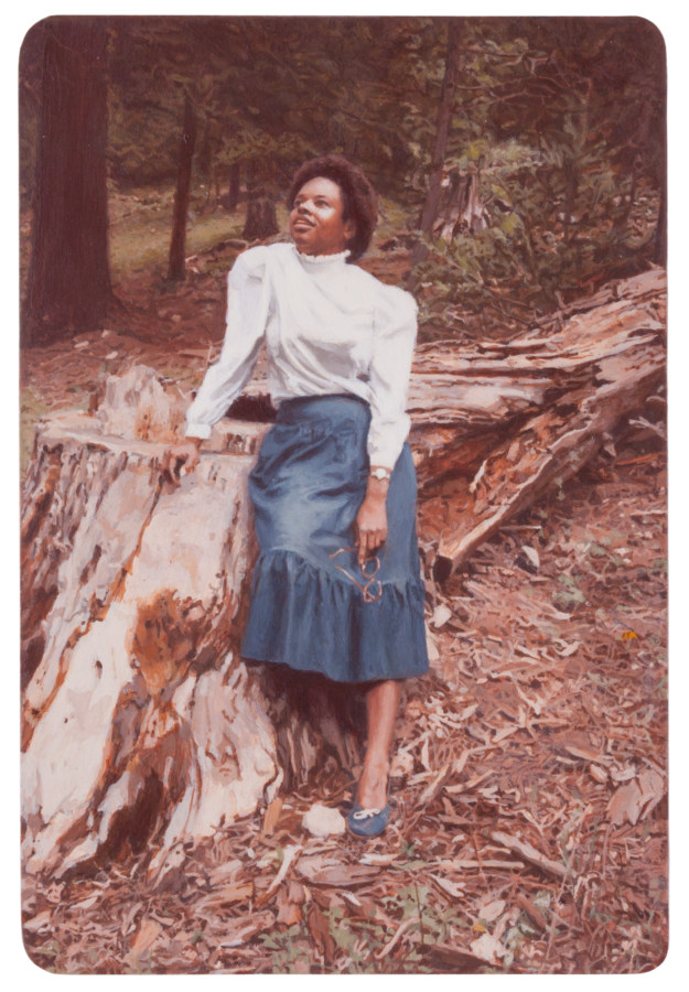 Color image of photorealistic painting of photograph depicting a young woman looking upward at sky while leaning on tree stump