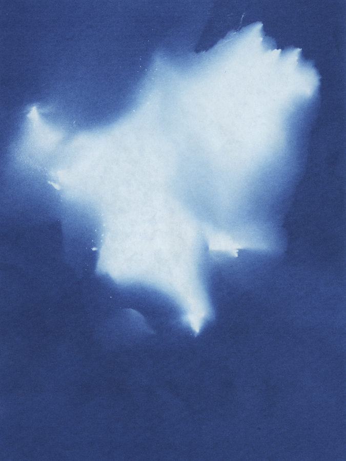 Color image of cyanotype depicting white form in top center of work