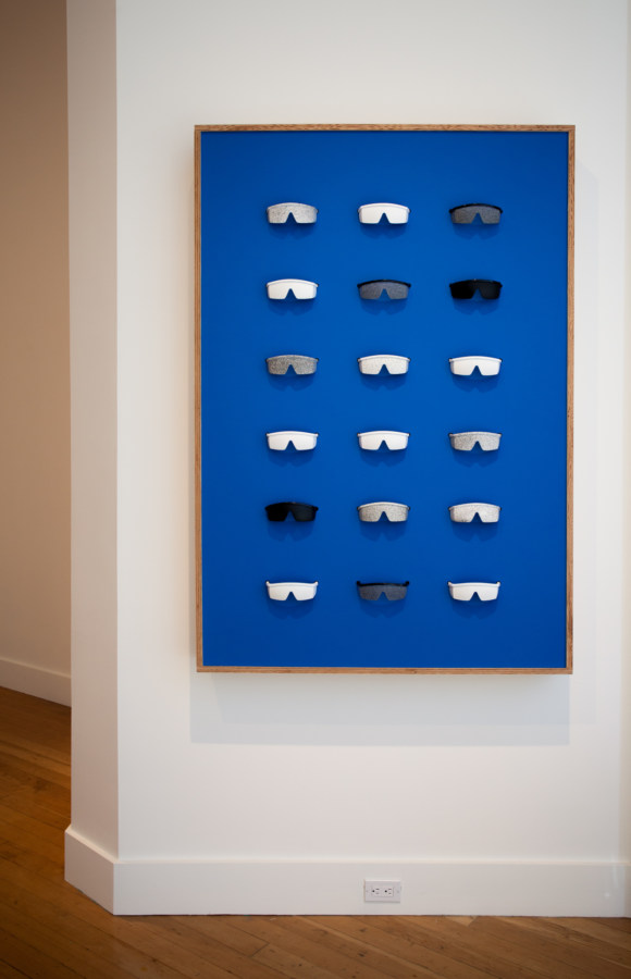 Color image of blue framed artwork with removable sensory deprivation glasses