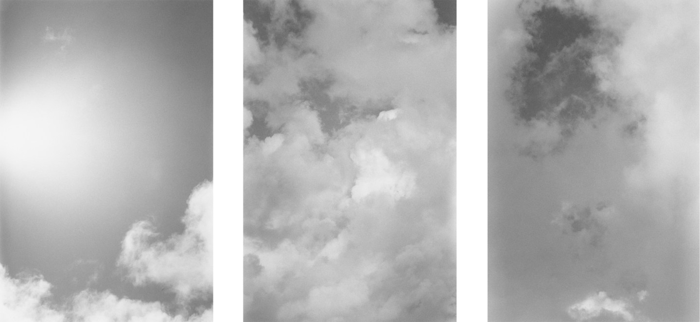Three black-and-white vertical photos of clouds and a brightly lit sky