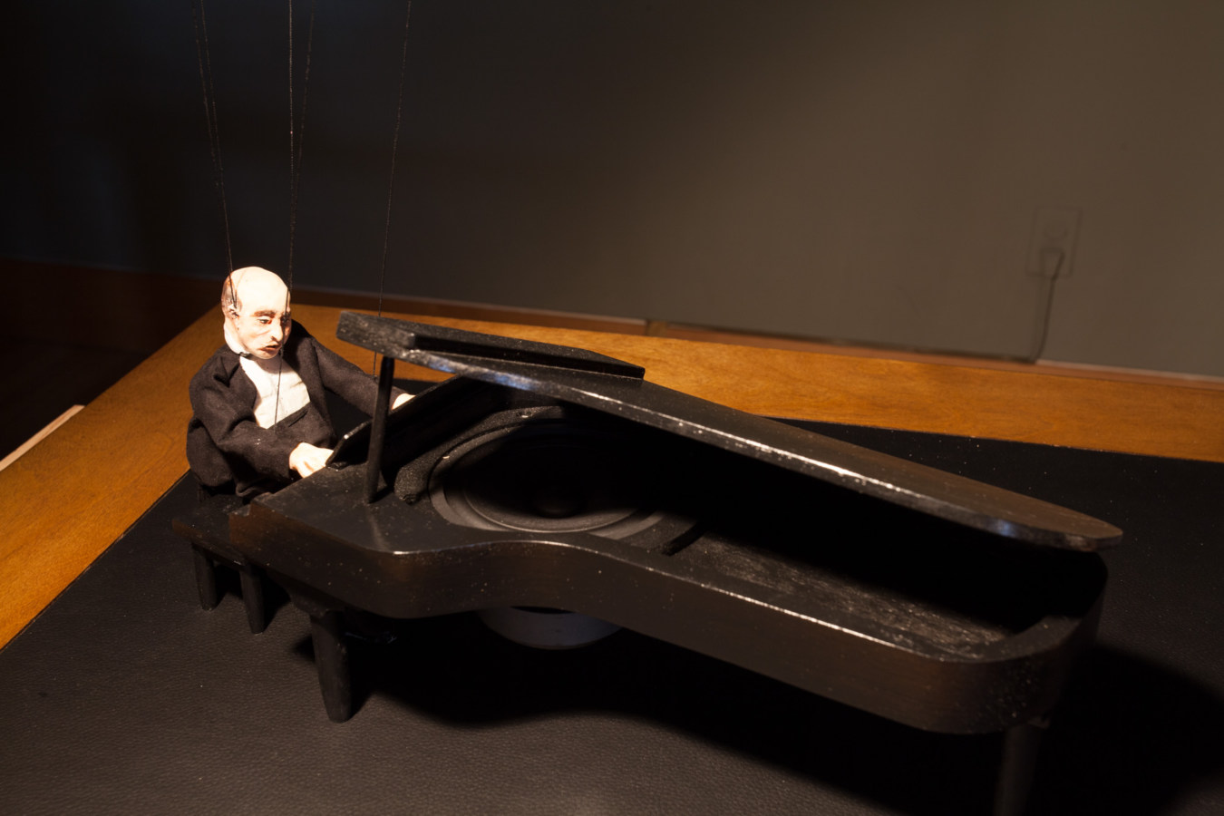 Color image of marionette depicting a pianist playing piano