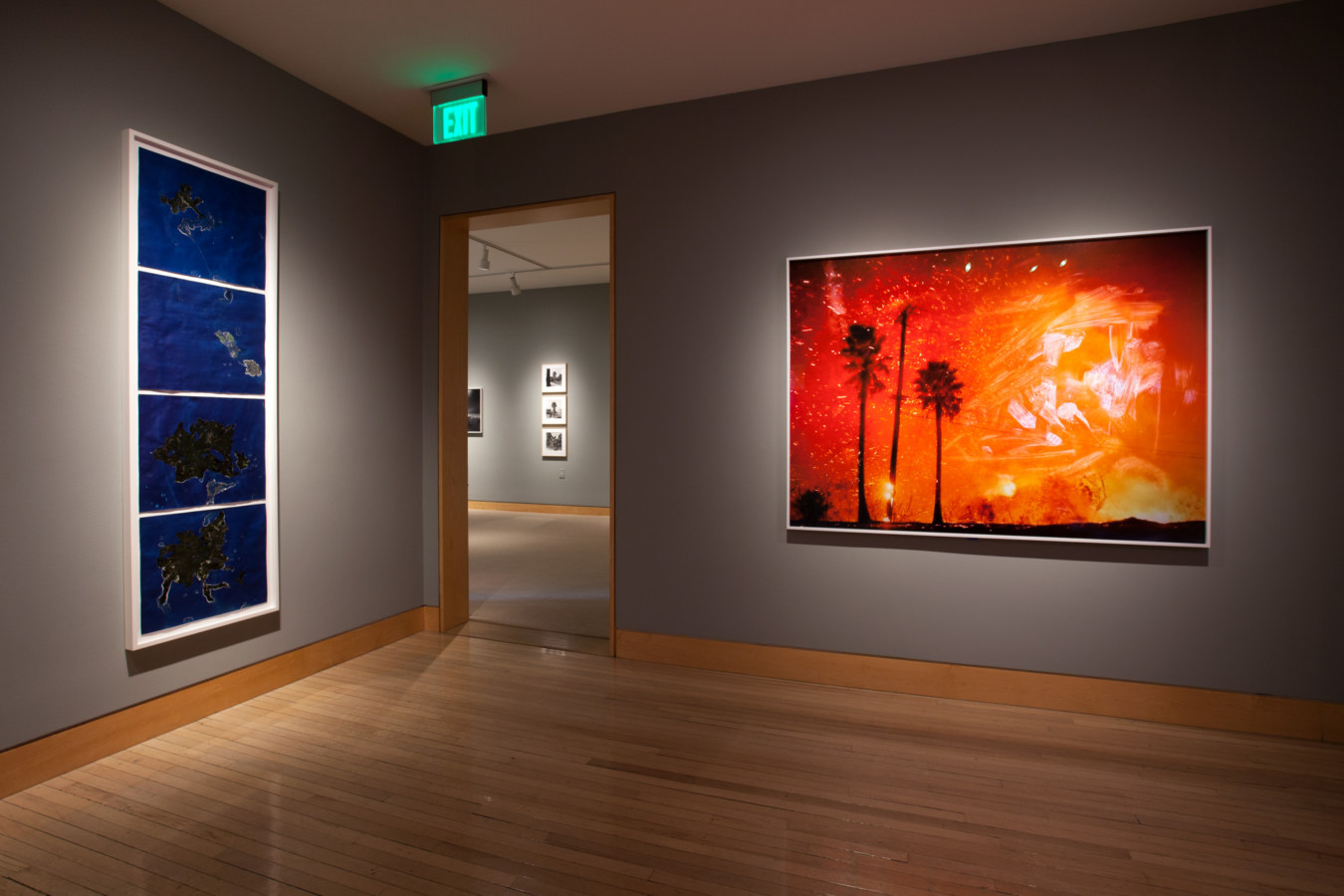 Color image of large scale color photographs on grey gallery walls