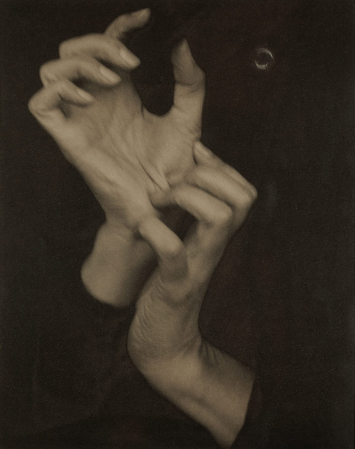 Toned black and white photograph of a woman's hands.