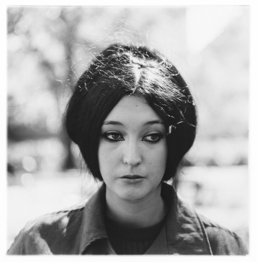 Black-and-white photograph of a woman with dark hair and dark eyeliner looking out of the frame