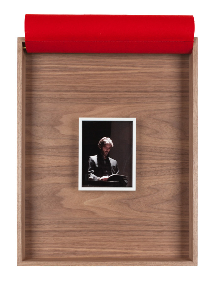 A framed photograph of a man in a suit, the bullfighter Jose Tomas, inside a wooden box