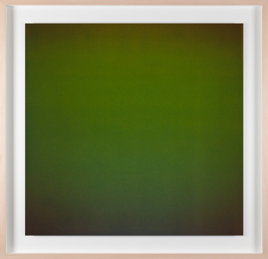 A framed photograph of a color field that is forrest green in the center and dark green at each corner