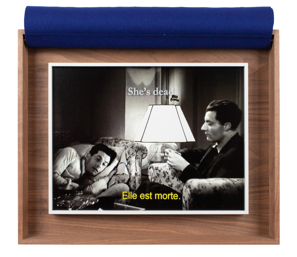 A wooden box with a photograph from a black and white movie inside