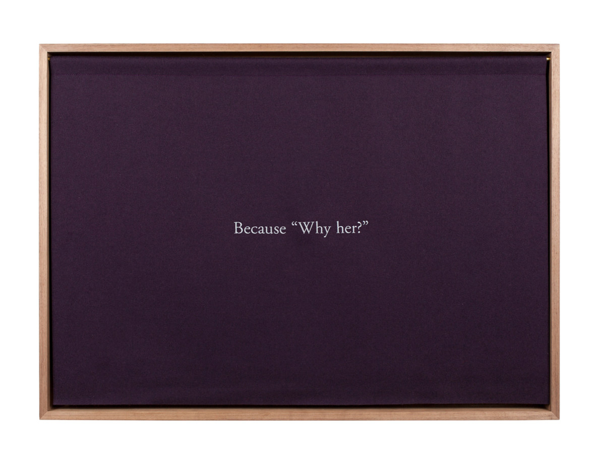 A wooden box, with a purple curtain embroidered with white text, "Because 'Why her?'"