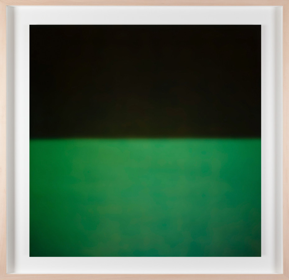 A framed photograph of a black and green color field