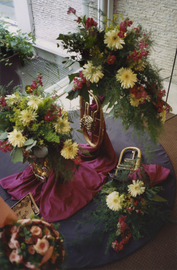 A photograph of flower arrangements, made inside various brass instruments.