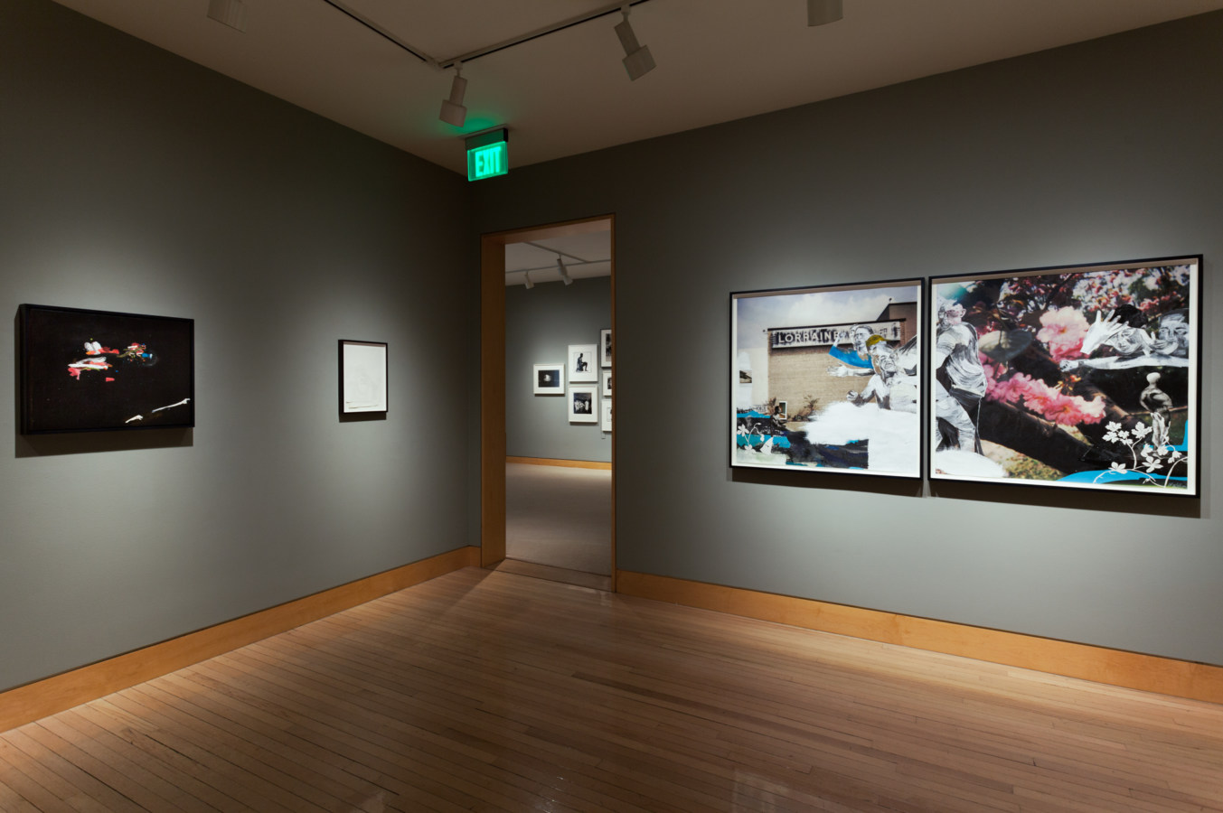Color image of framed mixed media artworks on grey gallery walls