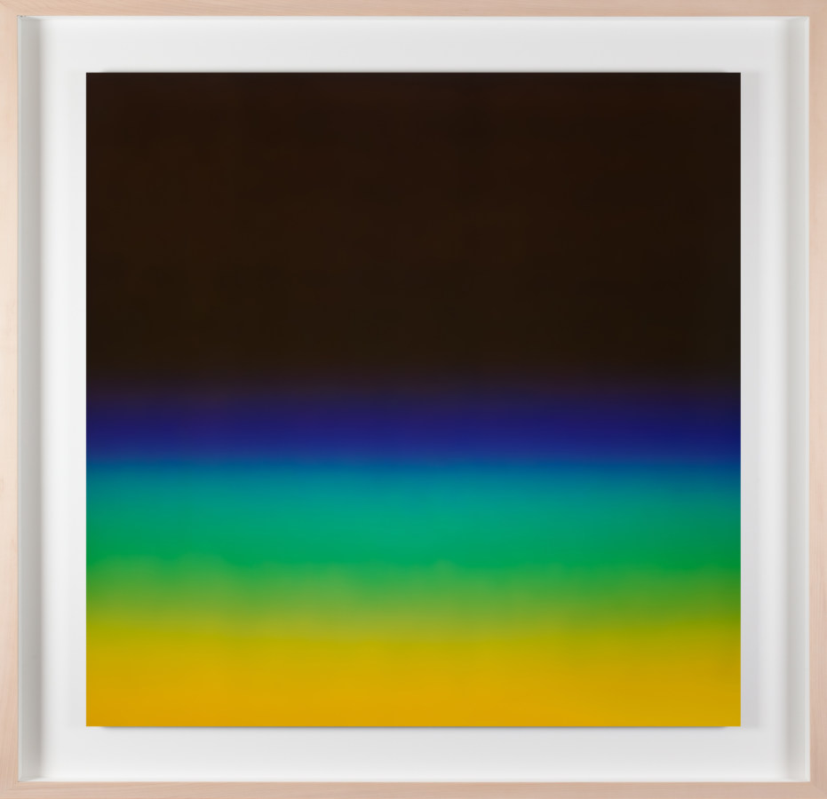 A framed photograph of a black color field with blue, green and yellow gradients on the bottom