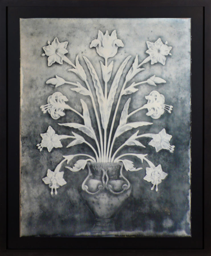 Framed image of a daguerreotype showing a showing a sculptural wall relief of flowers in a vase