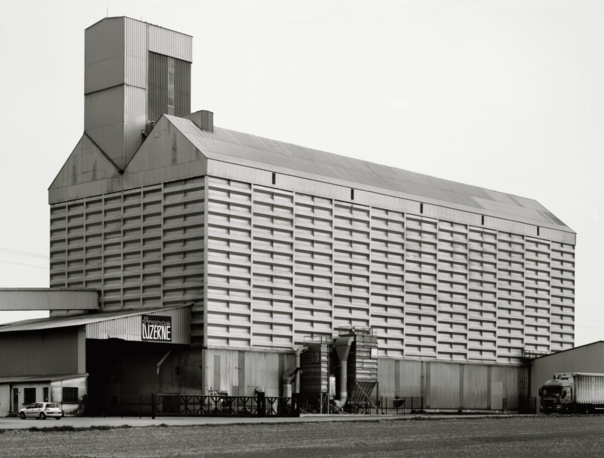 Black and white photograph of a large multi-storied grain elevator