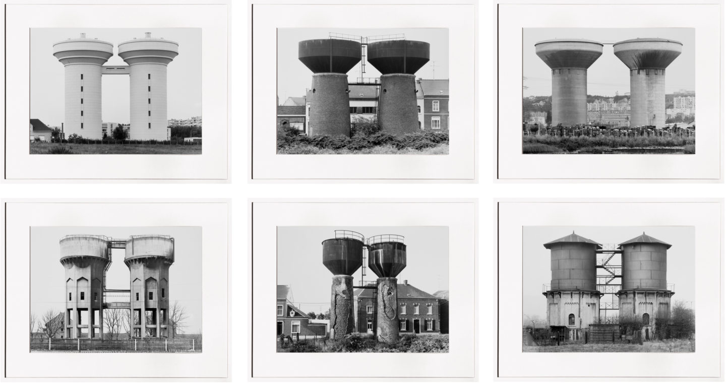 Grid of six framed black and white photographs of water towers
