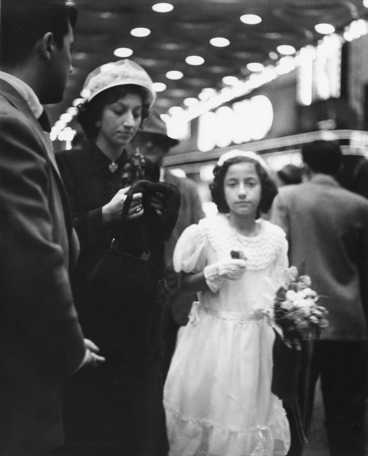 Black and white photograph of a woman in a dark dress and a young girl in a white dress.