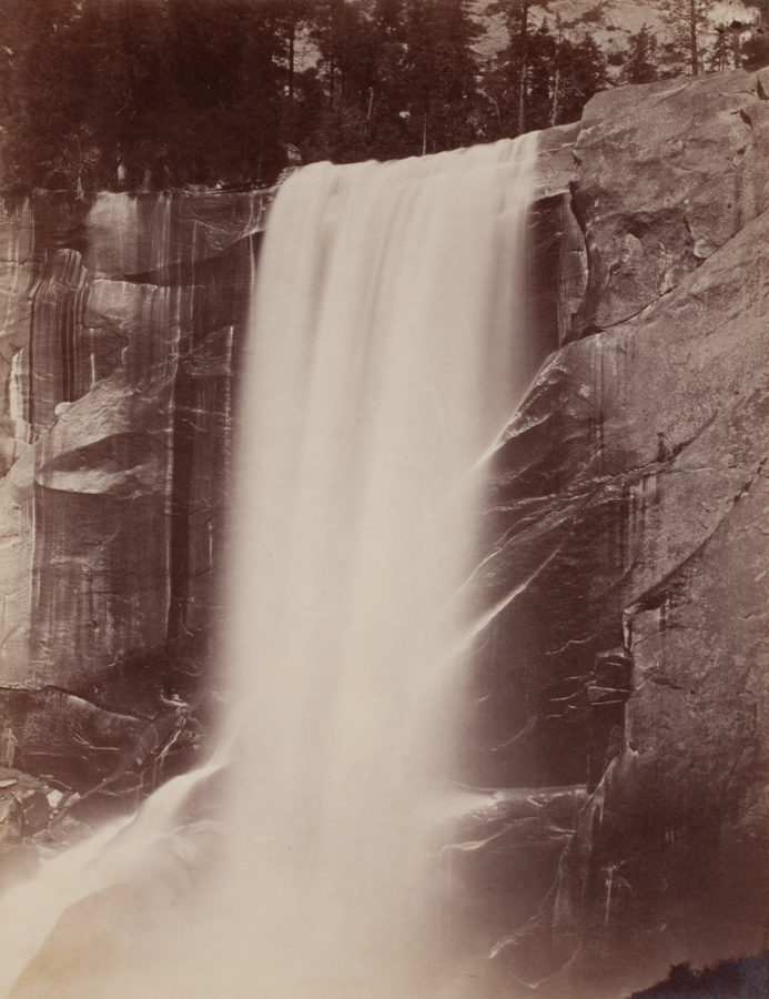 Ninteteenth century photograph of a large waterfall, coming off a cliff