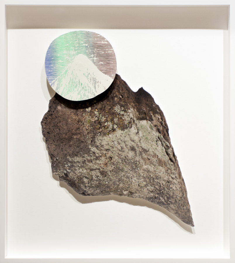 Collage of a rock with an iridescent circle imprinted with a mountain peak overlaid