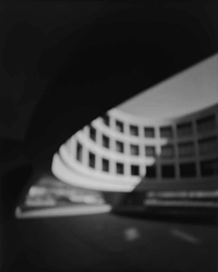 A black and white photograph, slightly blurred, of the courtyard at the Hirshhorn Museum and Sculpture Garden