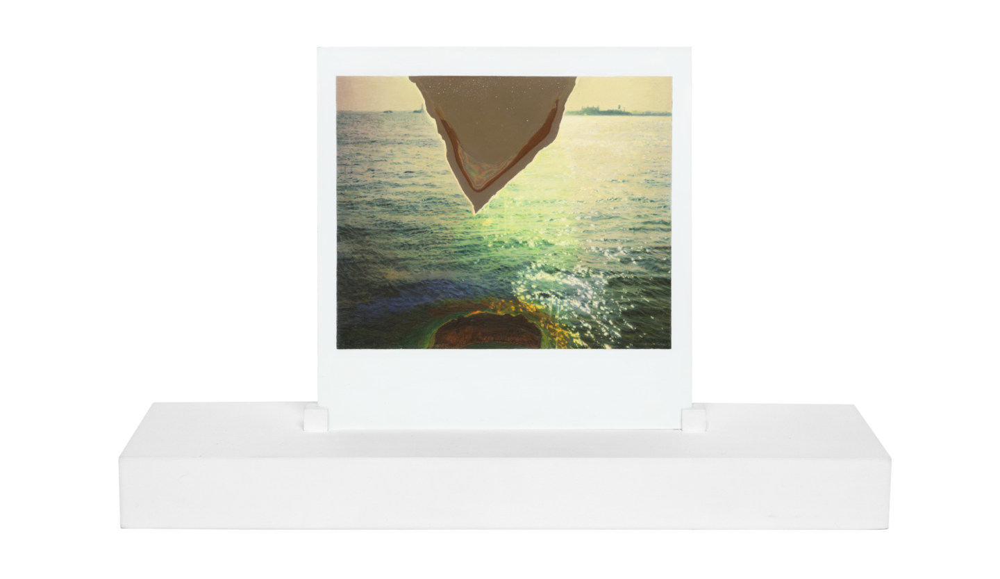 A painting of a polaroid photograph, on a white stand, made at one-to-one scale. The photograph depicts the surface of the ocean, with a triangle of emulsion loss cutting through the top center of the image.