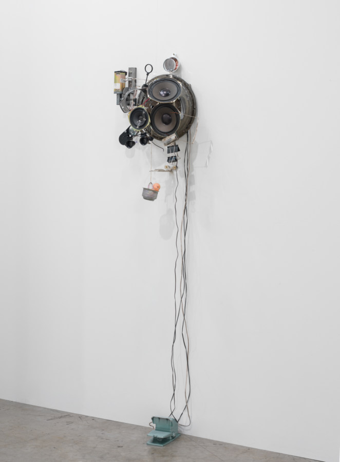 Installation view of a mixed-media sculpture installed on a wall.