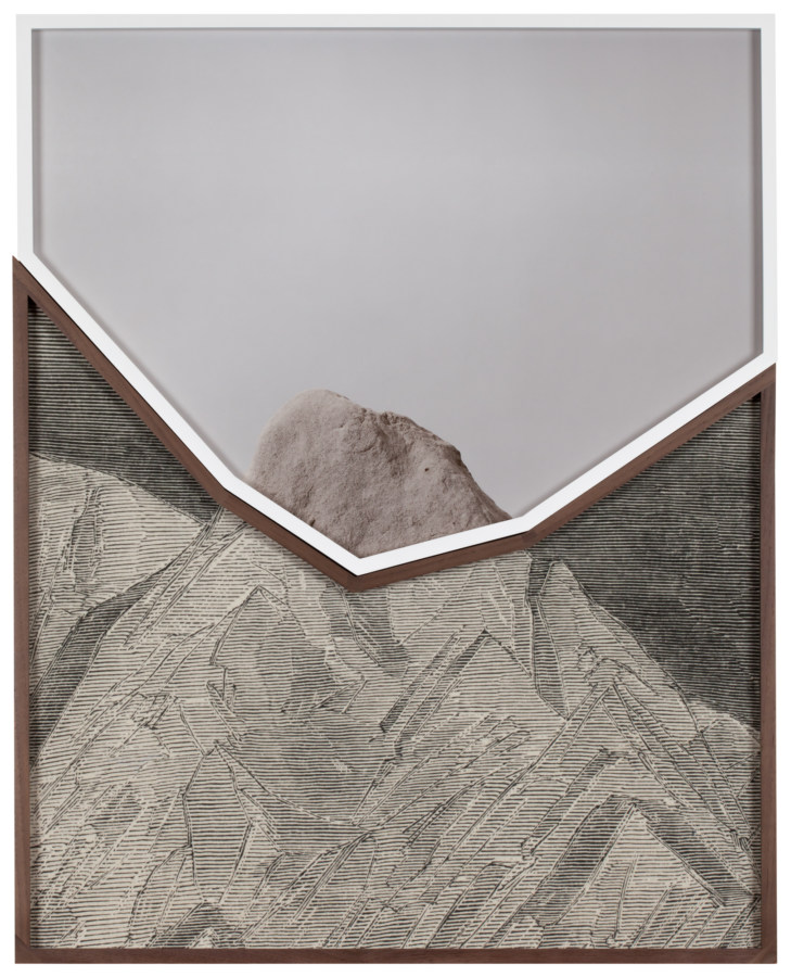 Two photographs in jagged-edge frames that fit together to form a rectangle. The top photograph is of a rock, and the bottom is of an etching of a mountain. The two come together to form a whole image of a mountain.