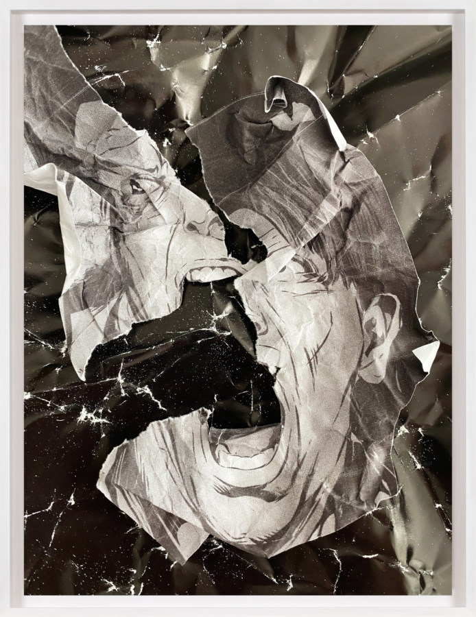 A framed collage of crumpled pages from comic books, with a torn screaming face at the center.